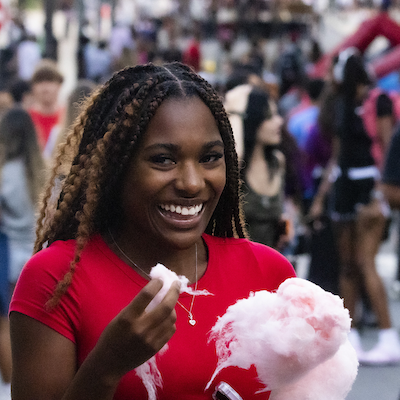 A student eating cotton candy.