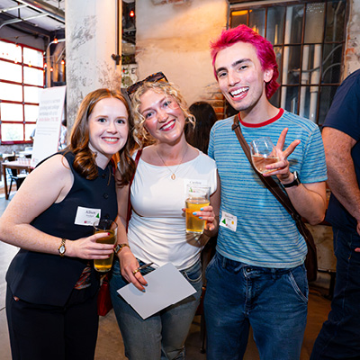 Three alumni posing for a picture.
