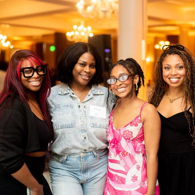 Four women pose for a picture.