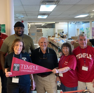 A group of alumni pose for a photo.