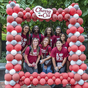 Students pose in a balloon frame.