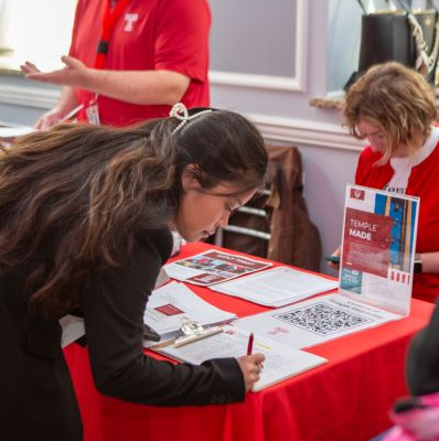 A student registers at a career fair.