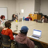 An image of students gathered around a table.