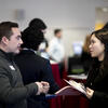 An image of two people speaking at a networking event. 