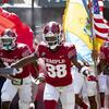 Temple's football team running onto the field.